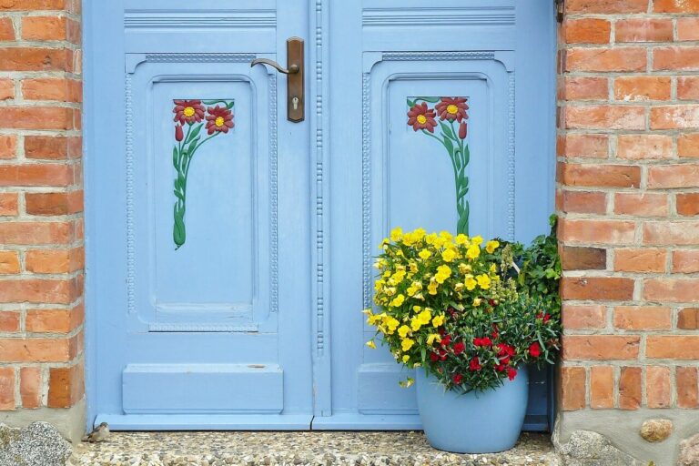 Top 5 tips for selling a home flowers at a blue door entrance to a house