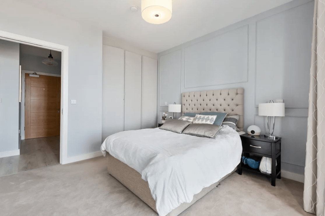 59 Campion Marina Village Greystones bedroom with large bed, wardrobes and door to hallway