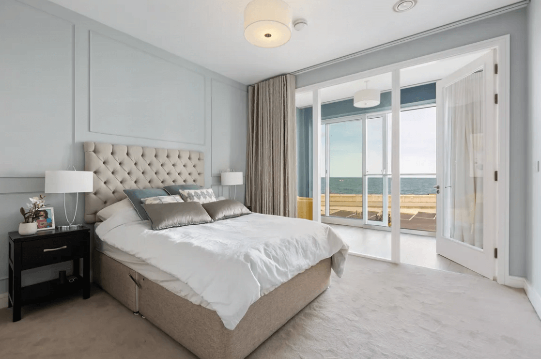 59 Campion Marina Village Greystones bedroom with large luxury bed and beige carpet with views of the sea
