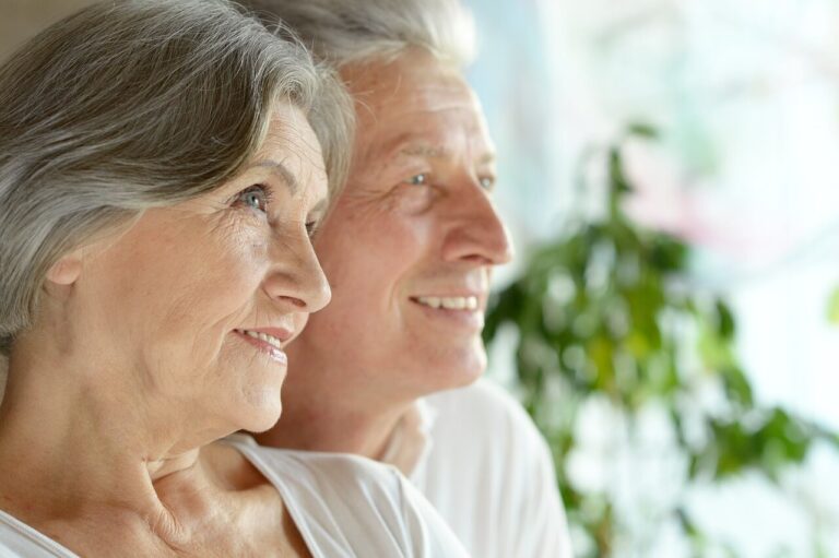 Fair Deal Valuations elderly couple smiling while talking to someone out of shot