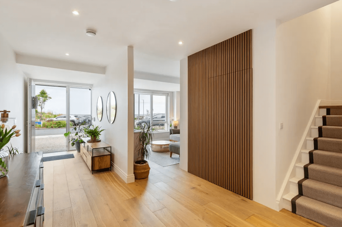 16 The Shore Greystones Wicklow George and Maguire Properties hallway of property with timber flooring, bright open spaces and the living room to the right