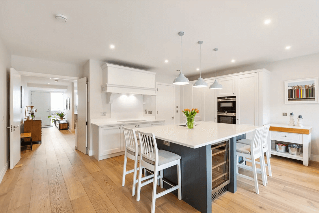 16 The Shore Greystones Wicklow George and Maguire Properties kitchen with timber flooring, large breakfast island and white cupboards