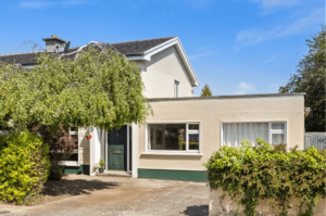 46 Charnwood Bray Wicklow Front View George and Maguire properties with a driveway, extension with two large windows, bushes and trees in the garden