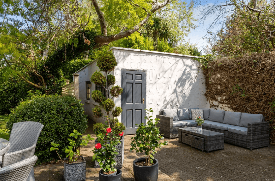 Balfour Ferndale Road Rathmichael Dublin George and Maguire Properties lounge area with small white shed and various trees with overhanging branches