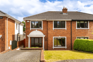 14 Shrewsbury Wood Cabinteely Dublin George and Maguire Properties front view of house with red brick facade, large garden and parking