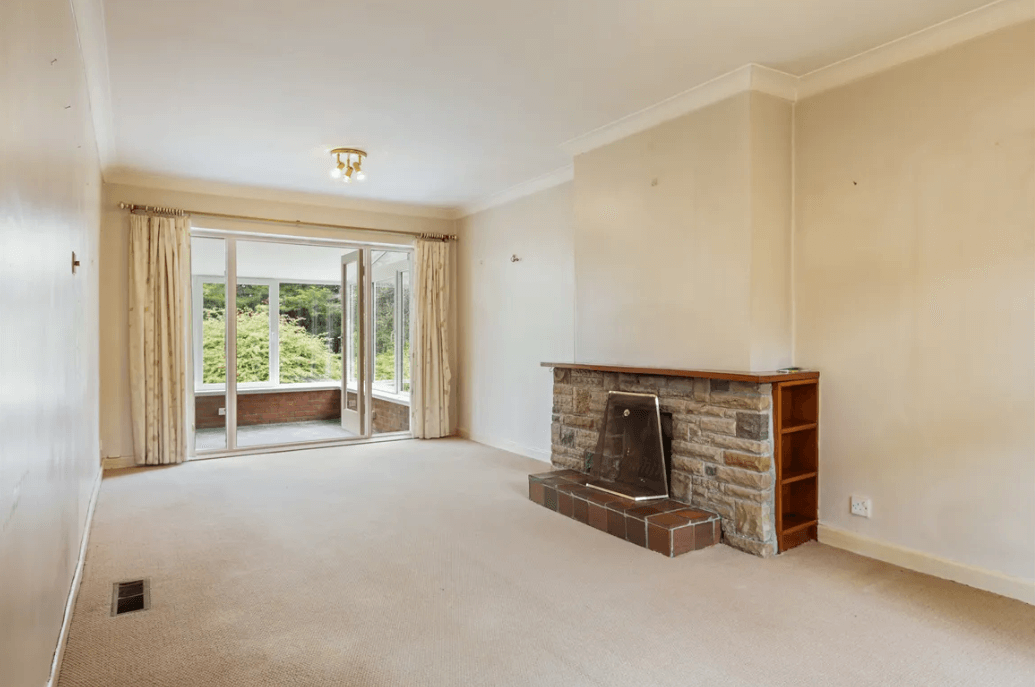 87 Shanganagh Vale Cabinteely Dublin George and Maguire Properties living room with fireplace, large window and cream carpet