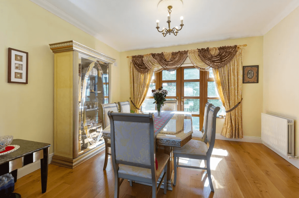 1 Leopardstown Rise Leopardstown Dublin 18 by George and Maguire Properties dining room with large table and chairs, a dresser, timber flooring and double doors to the rear garden