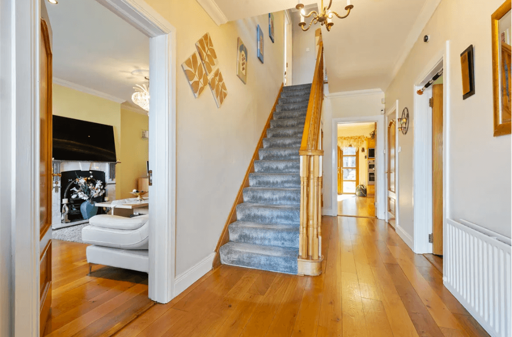 1 Leopardstown Rise Leopardstown Dublin 18 by George and Maguire Properties hallway with timber flooring, carpeted stairs and doors to various rooms of the house