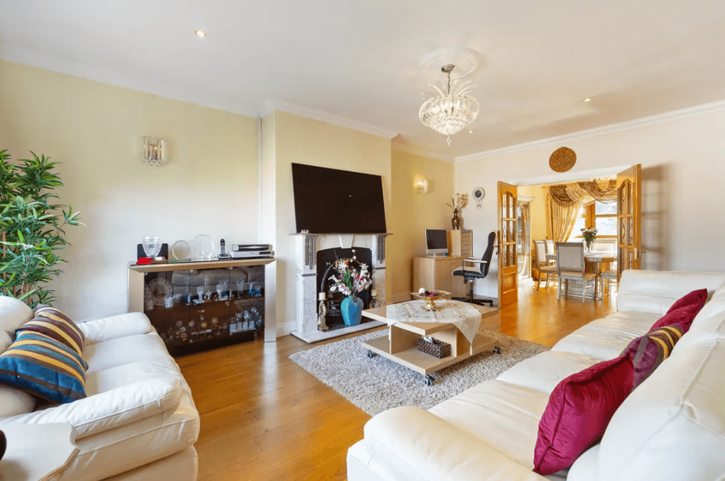 1 Leopardstown Rise Leopardstown Dublin 18 by George and Maguire Properties living room with timber floors, large cream sofas, fireplace and coffee tabel