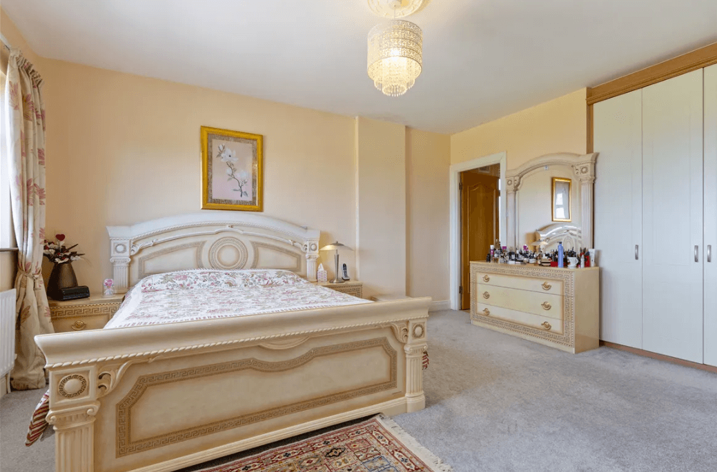 1 Leopardstown Rise Leopardstown Dublin 18 by George and Maguire Properties principal bedroom with large bed, carpeted floor and chest of drawers.