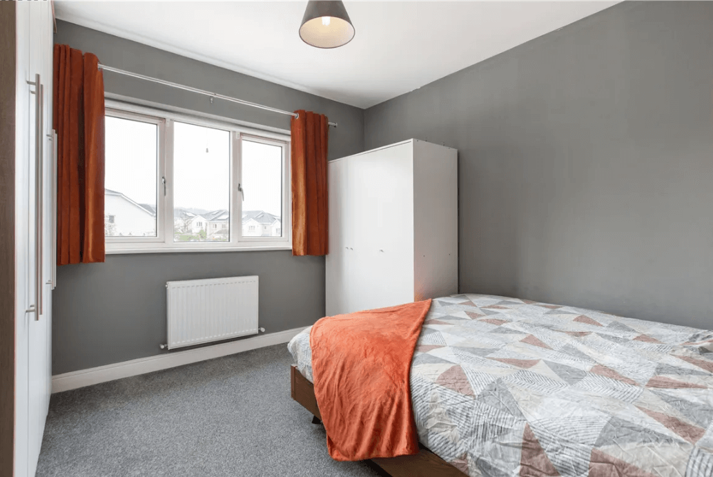 77 Monalin , Newtownmountkennedy, Wicklow George and Maguire Properties principal bedroom with luxury grey carpet, large window and large bed