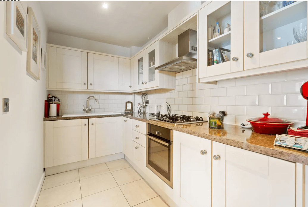 19 Rockbrae Hall Ticknock Hill Sandyford Dublin 18 George and Maguire Properties kitchen with white cupboards and appliances and white tiled floor