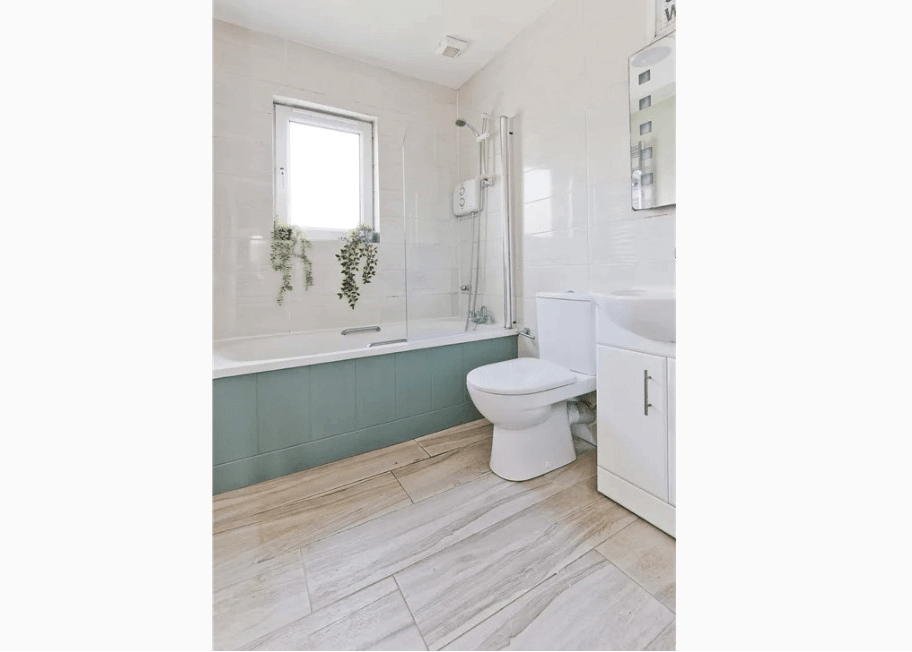 31 Herbert Bray Wicklow George and Maguire Properties family bathroom with full-sized bath, tiled walls, white toilet and sink with small window