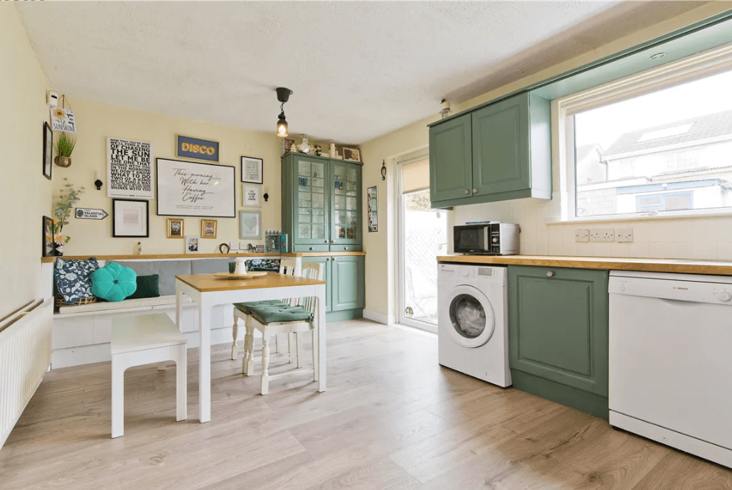 31 Herbert Bray Wicklow George and Maguire Properties kitchen and dining area with large white table and chairs, modern green cupboards and door to rear garden